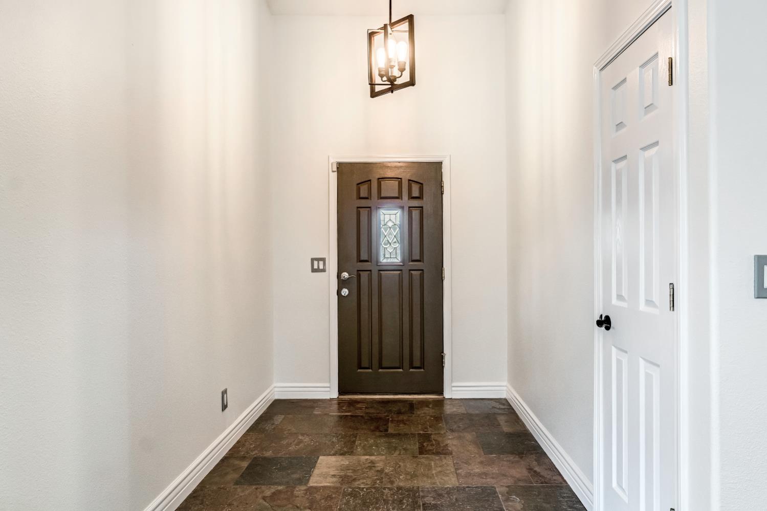 1571 Lemon Avenue Madera, CA 93637 - Photo 5 of 38 a view of a hallway with wooden floor