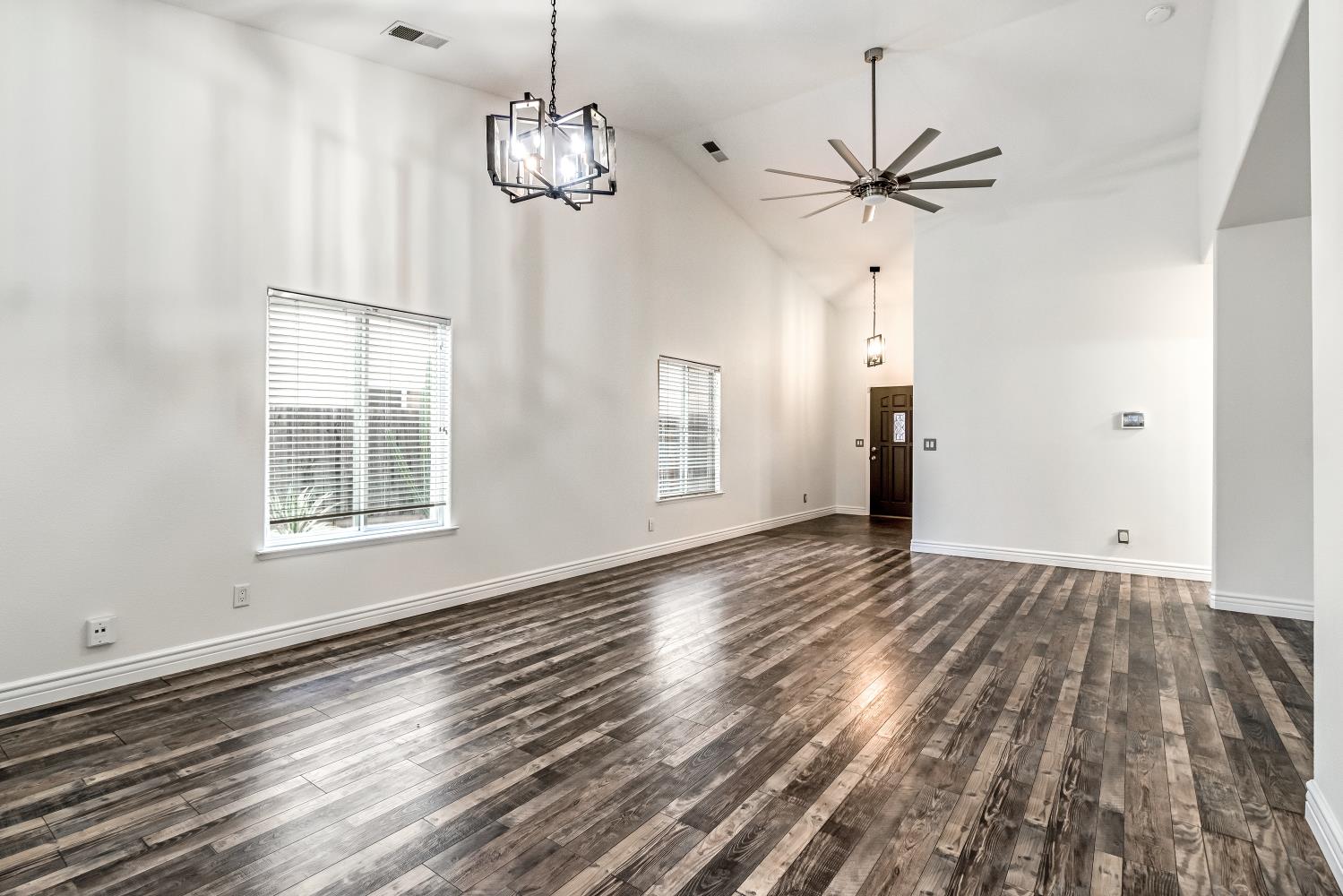 1571 Lemon Avenue Madera, CA 93637 - Photo 9 of 38 a view of an empty room with wooden floor and a window