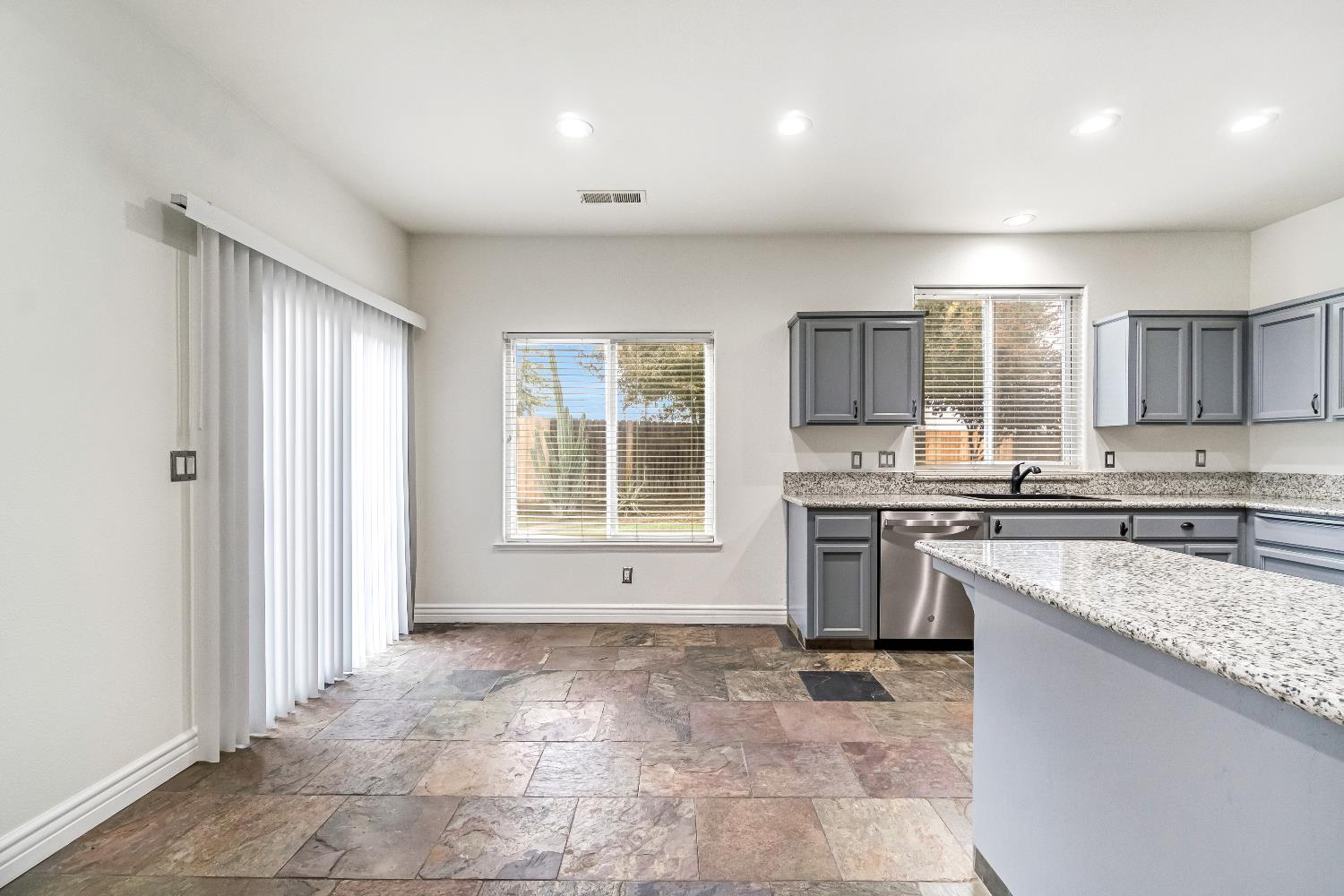 1571 Lemon Avenue Madera, CA 93637 - Photo 10 of 38 a kitchen with a stove a sink and a refrigerator