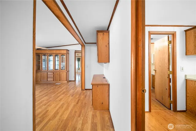 a view of a hallway with wooden floor and staircase