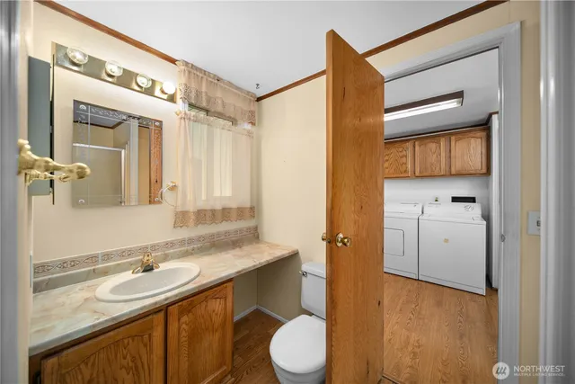 a bathroom with a granite countertop sink toilet and a mirror