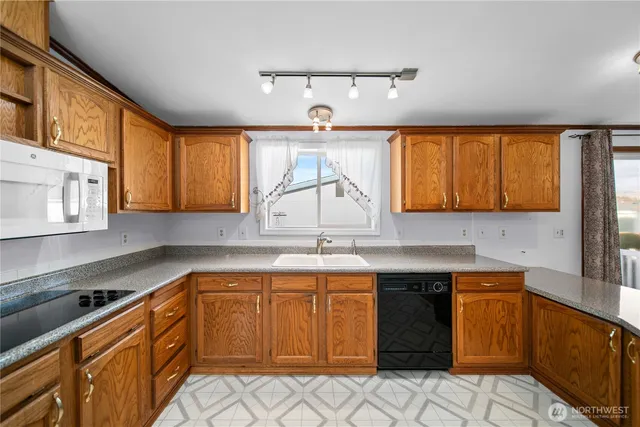 a kitchen with a sink stove and cabinets