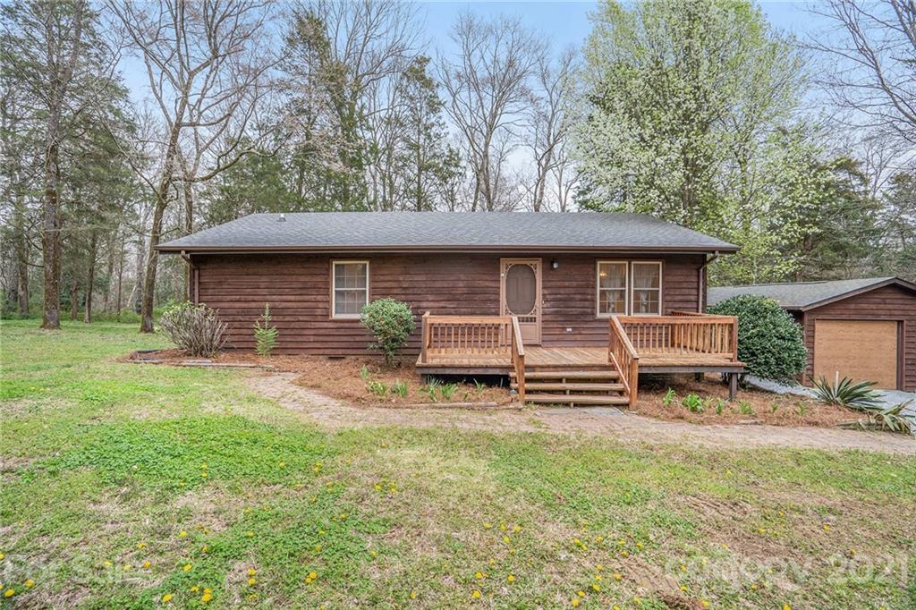 4325 Flowes Store Road Concord, NC 28025 - Photo 2 of 31 a front view of a house with a garden