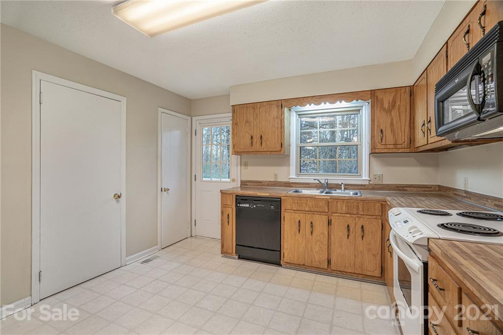 4325 Flowes Store Road Concord, NC 28025 - Photo 18 of 31 a kitchen with stainless steel appliances granite countertop a stove and a sink