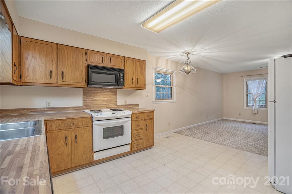 4325 Flowes Store Road Concord, NC 28025 - Photo 20 of 31 a kitchen with a stove top oven sink and cabinets