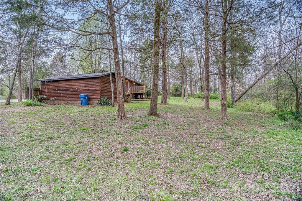 4325 Flowes Store Road Concord, NC 28025 - Photo 8 of 31 a view of a backyard with large trees