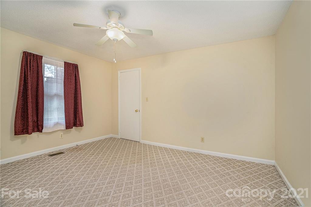 4325 Flowes Store Road Concord, NC 28025 - Photo 10 of 31 wooden floor in an empty room with a window