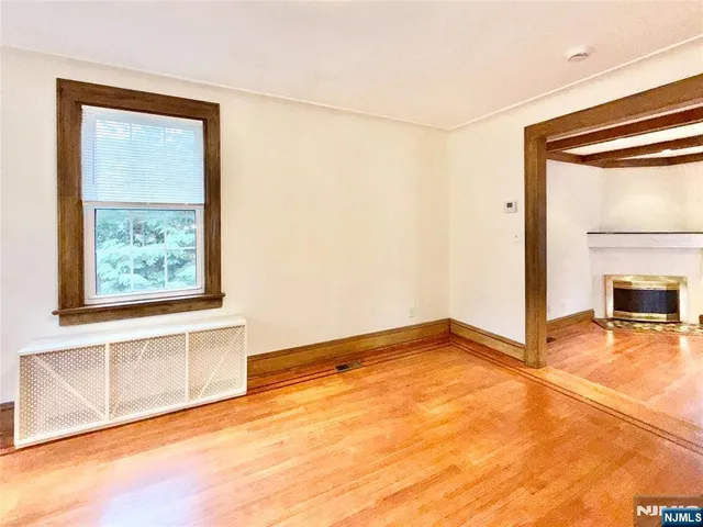 an empty room with a fireplace and painted walls