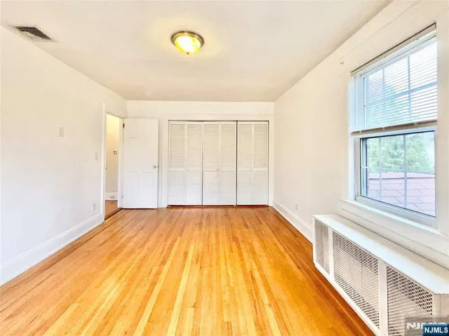 a view of a room with wooden floor and fan
