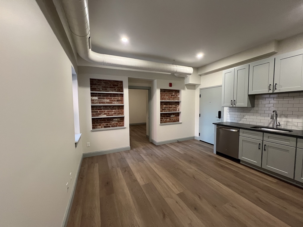 160 Seabury Street, Unit 6 Fall River, MA 02720 - Photo 4 of 10 a kitchen with granite countertop a stove and a refrigerator