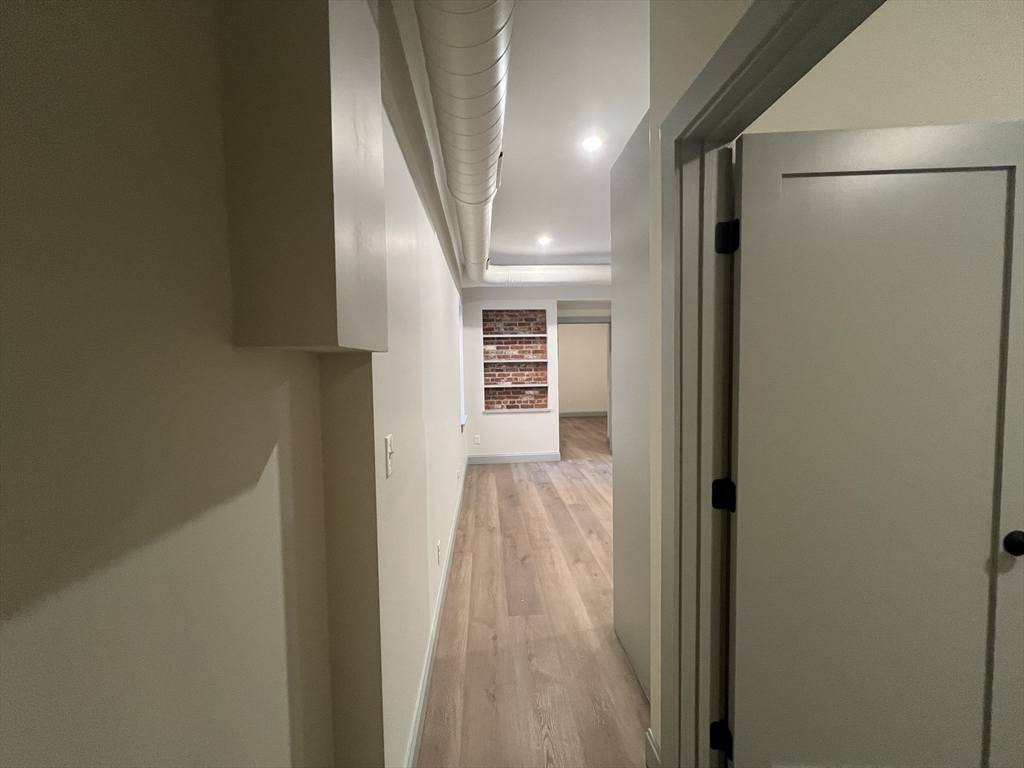 160 Seabury Street, Unit 6 Fall River, MA 02720 - Photo 7 of 10 a view of a hallway with wooden floor and staircase