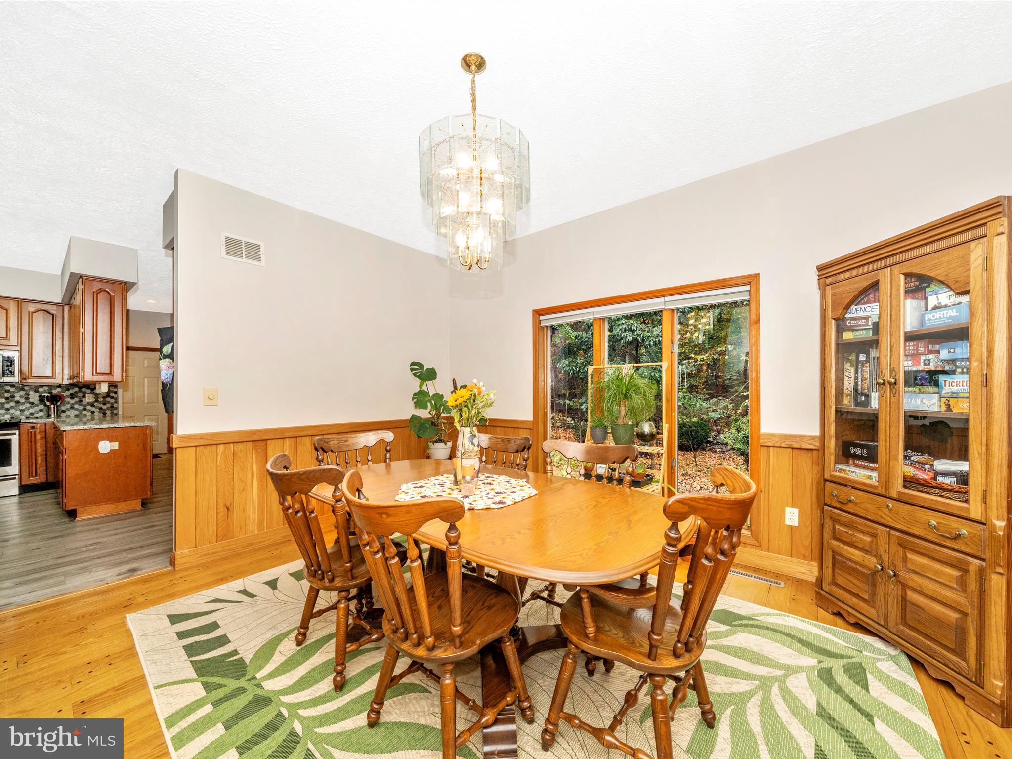 17879 Harbaugh Valley Road Sabillasville, MD 21780 - Photo 16 of 64 a view of a dining room with furniture and a chandelier