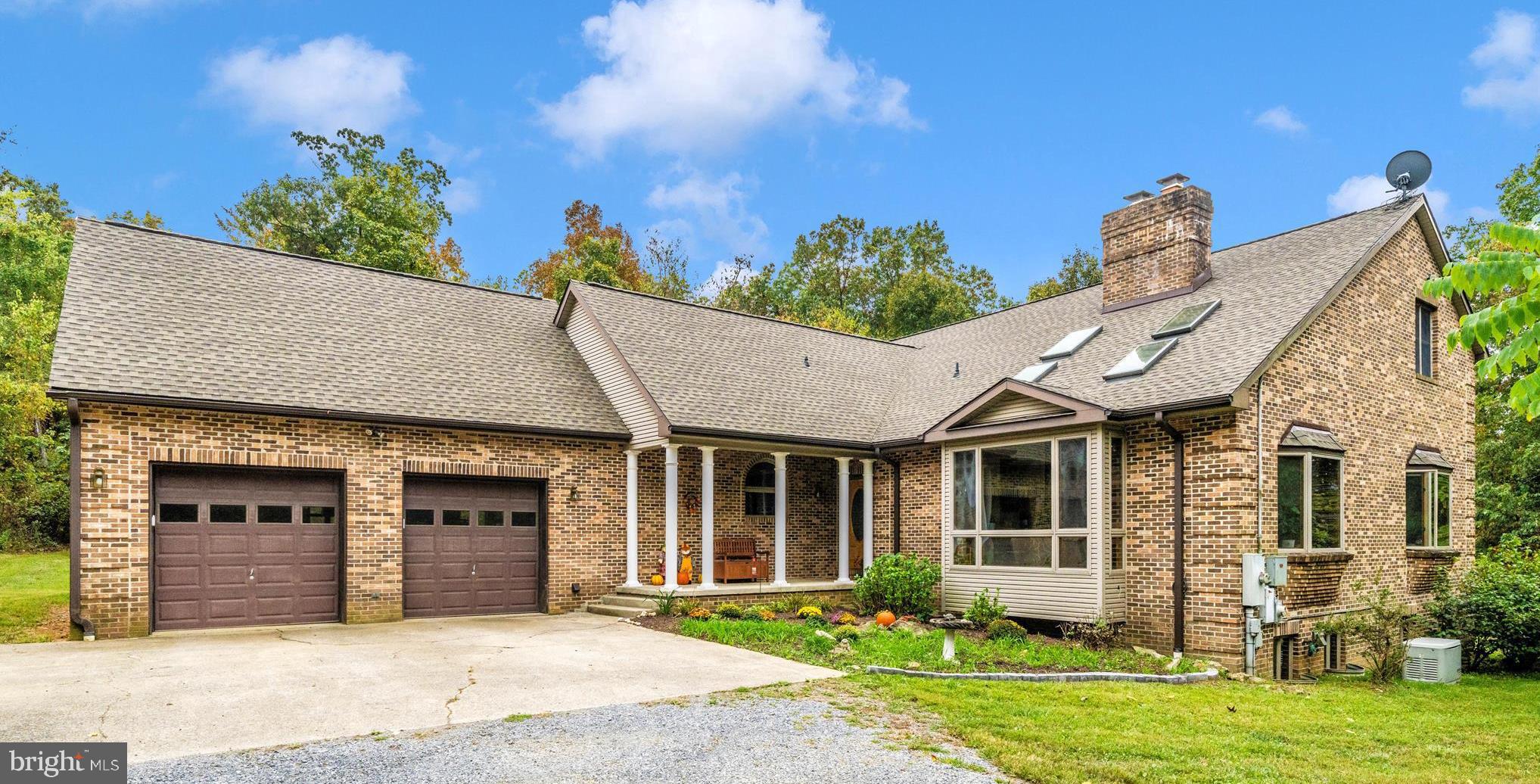 17879 Harbaugh Valley Road Sabillasville, MD 21780 - Photo 2 of 64 a front view of a house with a garden and plants