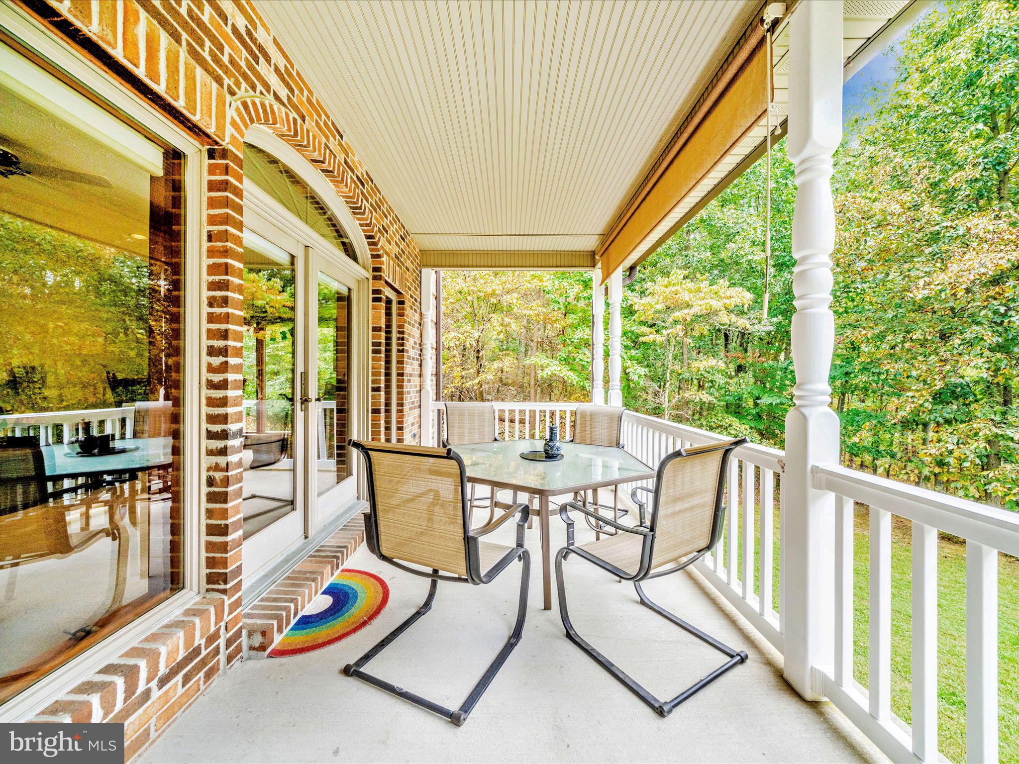 17879 Harbaugh Valley Road Sabillasville, MD 21780 - Photo 23 of 64 a view of a patio with a table chairs and wooden floor