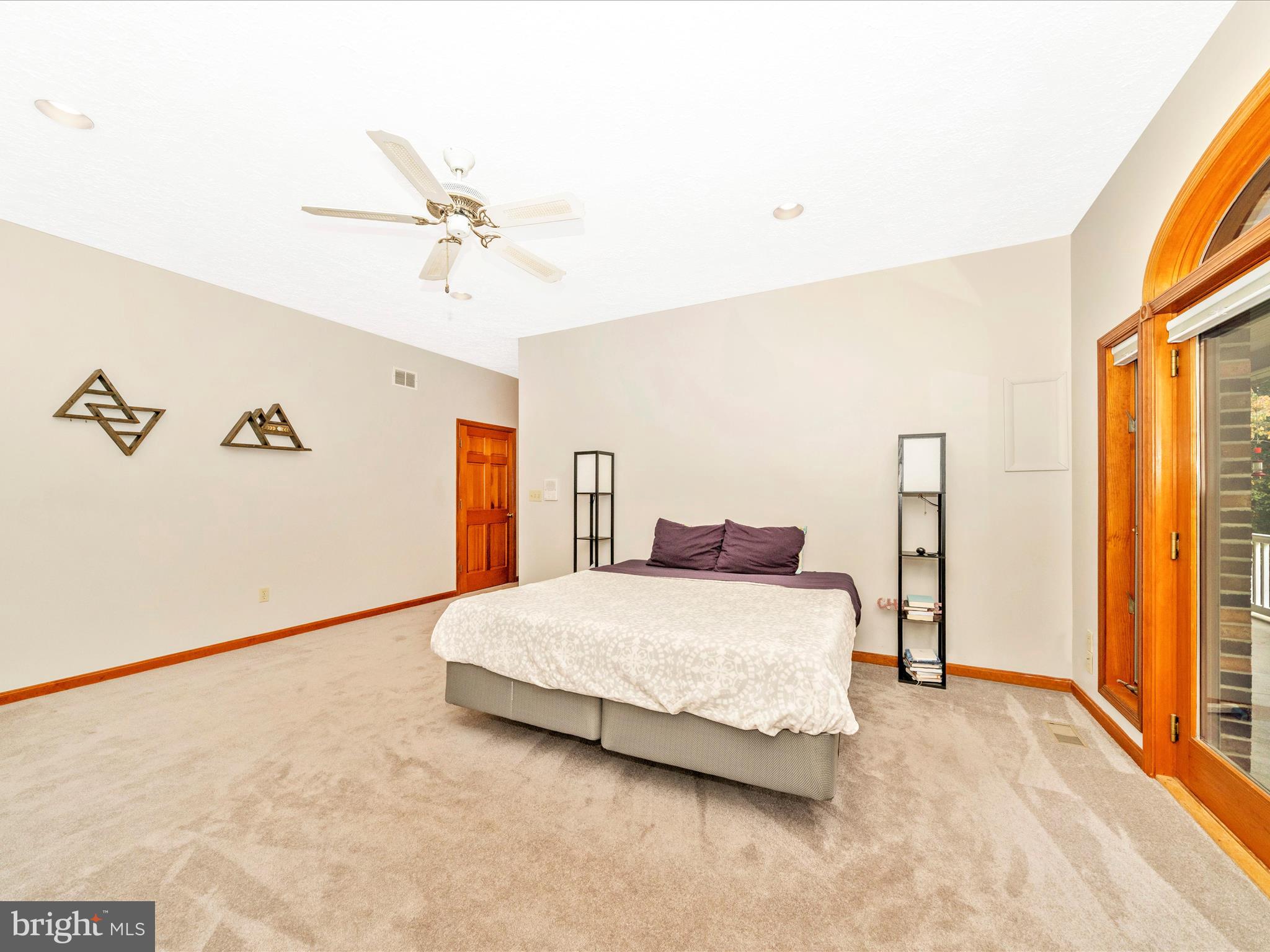 17879 Harbaugh Valley Road Sabillasville, MD 21780 - Photo 27 of 64 a bedroom with a large bed and a chandelier