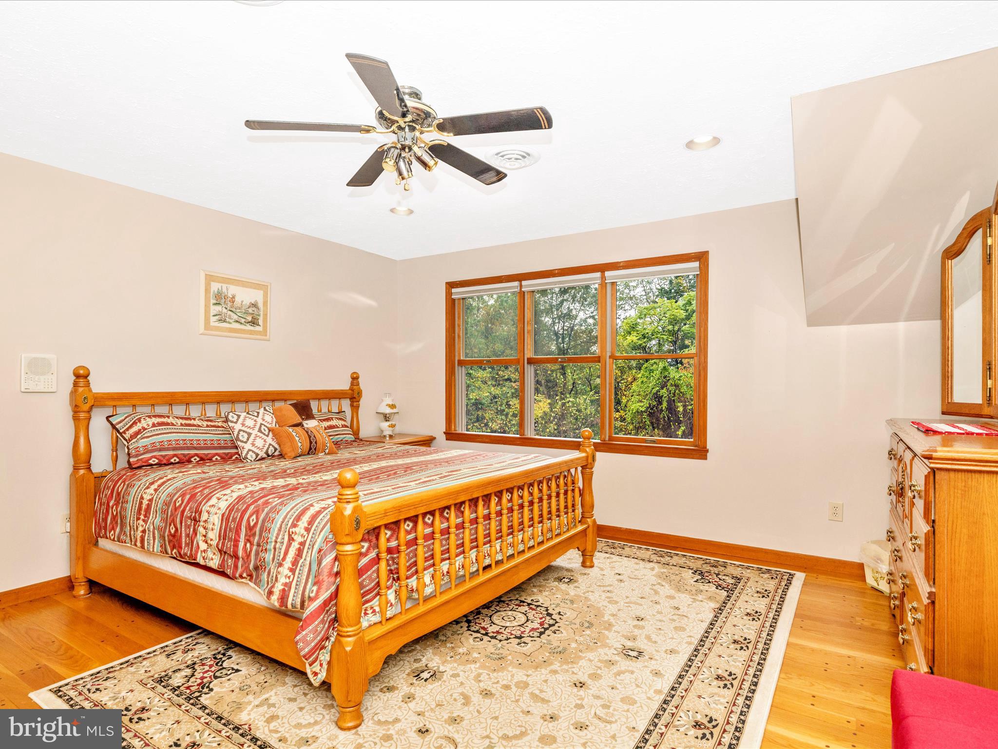 17879 Harbaugh Valley Road Sabillasville, MD 21780 - Photo 32 of 64 a bedroom with a large bed and a window