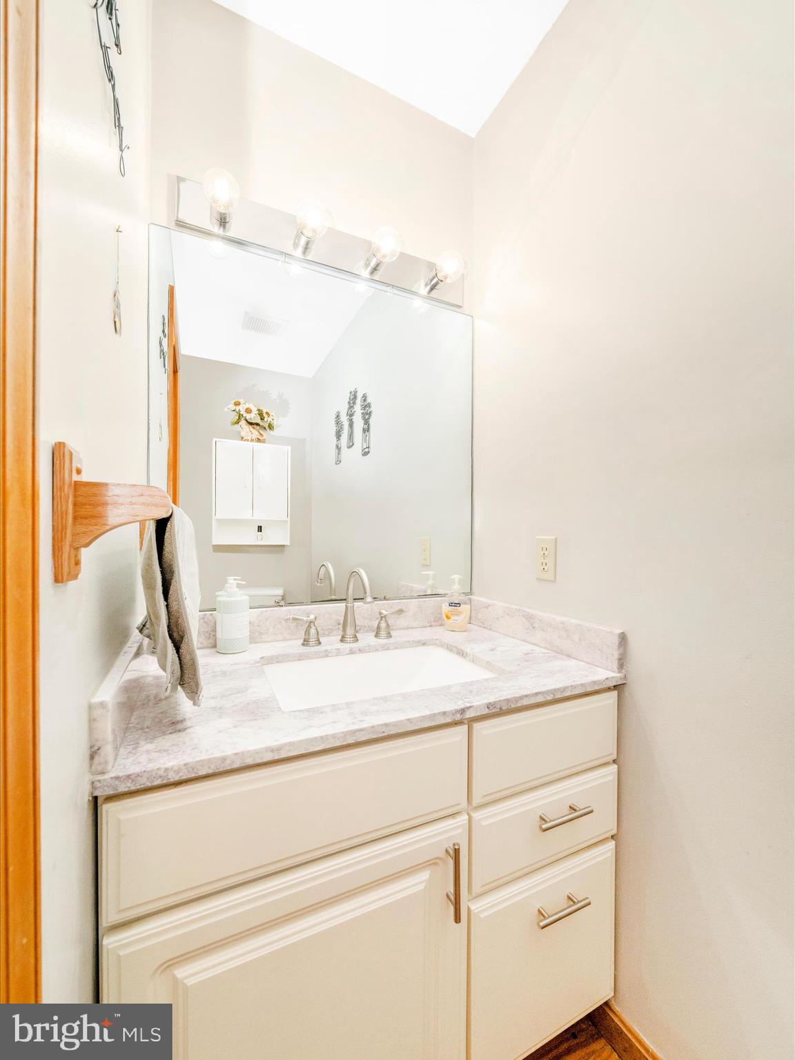 17879 Harbaugh Valley Road Sabillasville, MD 21780 - Photo 41 of 64 a bathroom with a granite countertop sink and a mirror