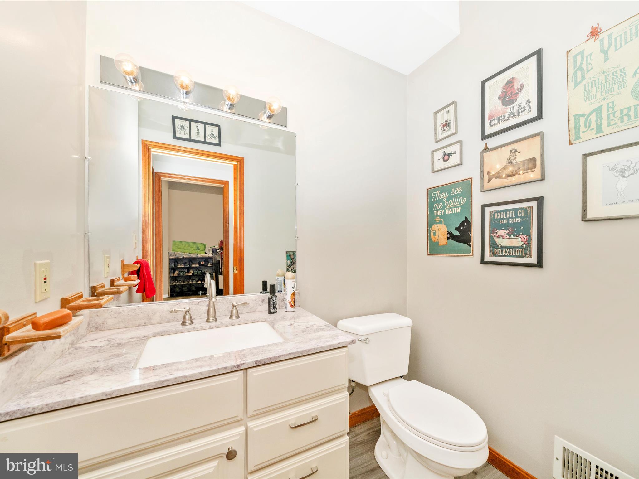 17879 Harbaugh Valley Road Sabillasville, MD 21780 - Photo 42 of 64 a bathroom with a granite countertop sink mirror vanity and toilet