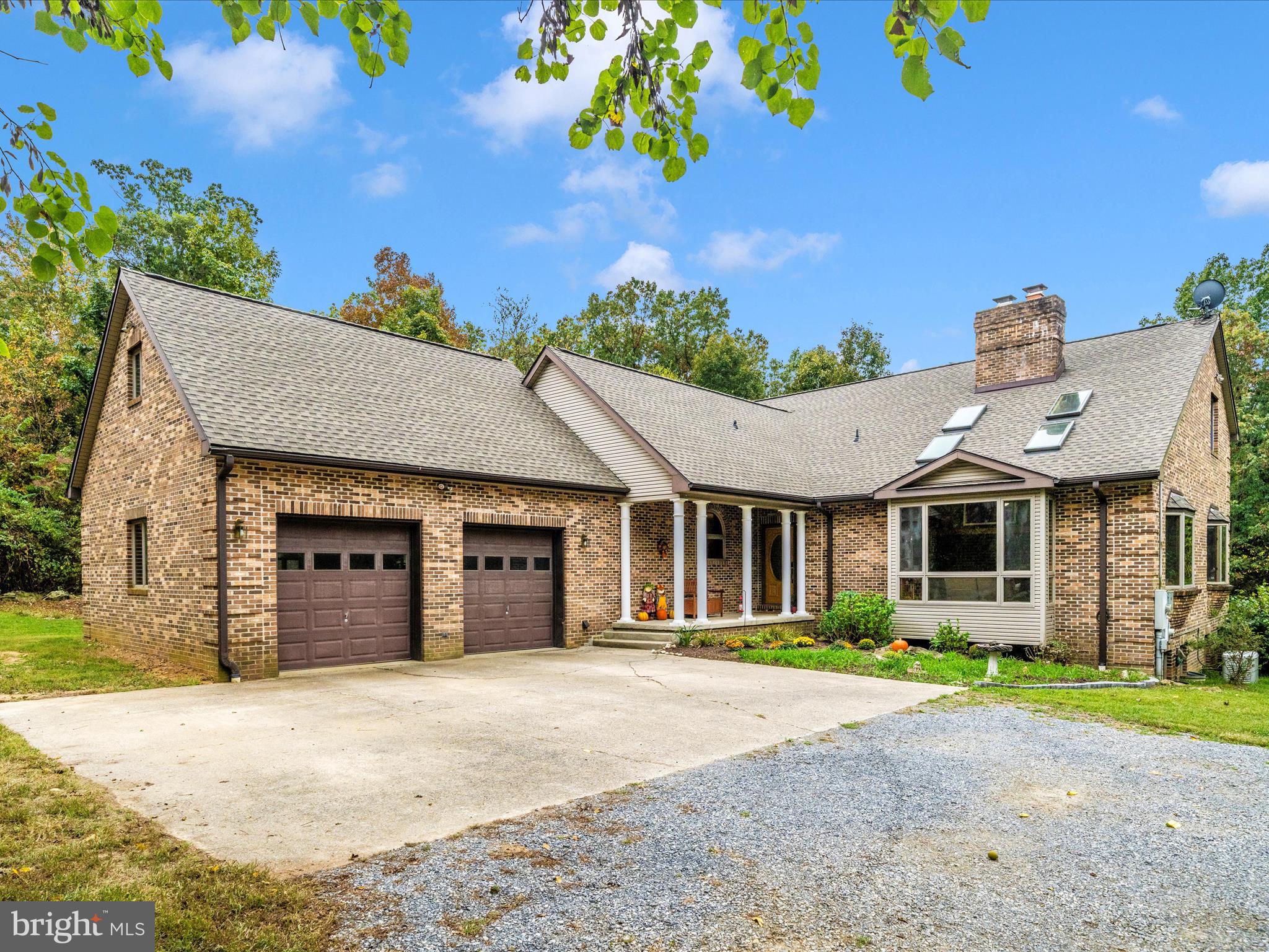 17879 Harbaugh Valley Road Sabillasville, MD 21780 - Photo 57 of 64 a front view of a house with a yard and garage