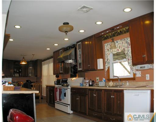 1232 West Farms Road Howell, NJ 07731 - Photo 7 of 23 a kitchen with stainless steel appliances granite countertop a sink and cabinets
