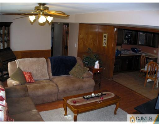 1232 West Farms Road Howell, NJ 07731 - Photo 9 of 23 a living room with furniture and wooden floor