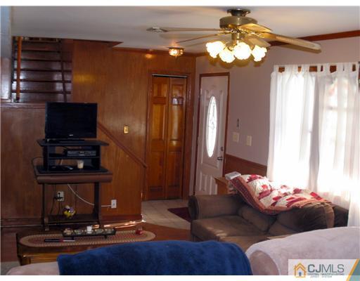 1232 West Farms Road Howell, NJ 07731 - Photo 10 of 23 a bedroom with a bed and a chandelier