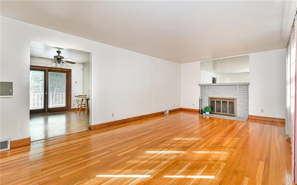 118 Lower Arrowhead Road Pittsburgh, PA 15237 - Photo 2 of 25 a view of empty room with wooden floor and fireplace