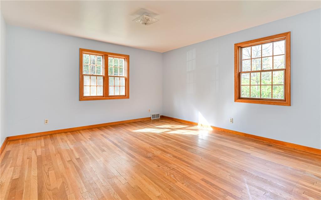 118 Lower Arrowhead Road Pittsburgh, PA 15237 - Photo 11 of 25 an empty room with wooden floor and windows