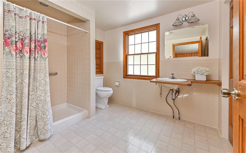 118 Lower Arrowhead Road Pittsburgh, PA 15237 - Photo 14 of 25 a spacious bathroom with a granite countertop sink a toilet and shower