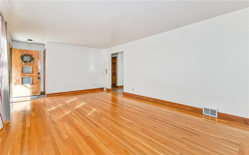 118 Lower Arrowhead Road Pittsburgh, PA 15237 - Photo 3 of 25 a view of an empty room with wooden floor and a window