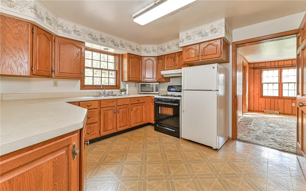 118 Lower Arrowhead Road Pittsburgh, PA 15237 - Photo 7 of 25 a kitchen with a refrigerator sink and cabinets