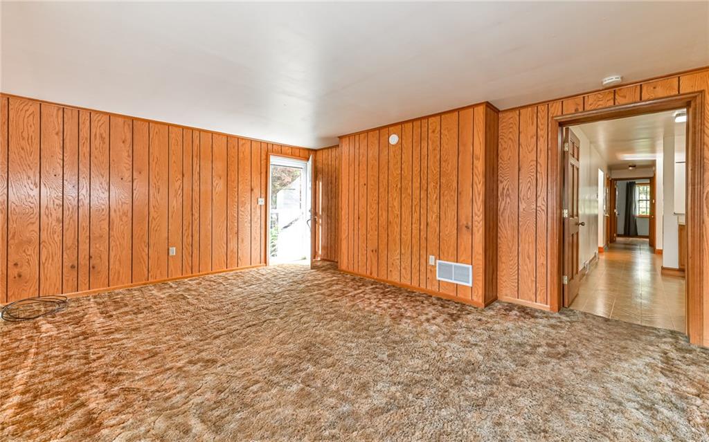 118 Lower Arrowhead Road Pittsburgh, PA 15237 - Photo 9 of 25 an empty room with wooden floor and windows with curtains