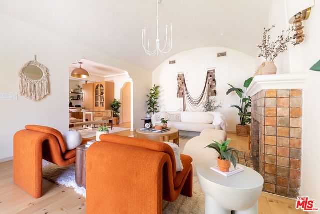 a view of living room with a large window and chandelier