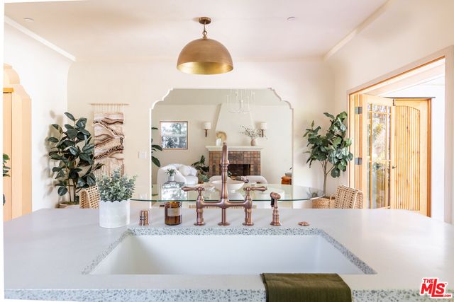 a large kitchen with stainless steel appliances granite countertop a lot of counter space and wooden floors