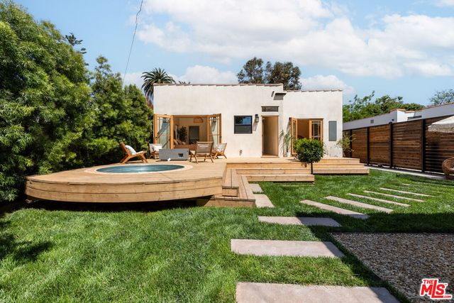 a living room with furniture fireplace and a large window