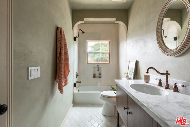 a bedroom with bed and a window