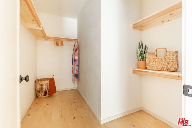 a living room with patio furniture and a potted plant