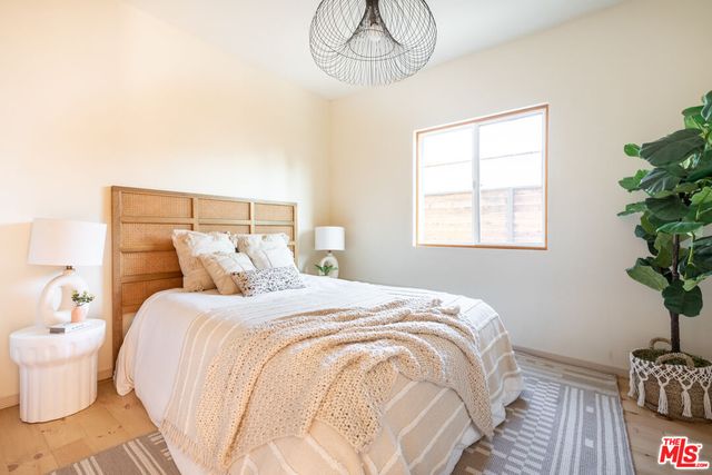 a bathroom with a sink a toilet a window and mirror