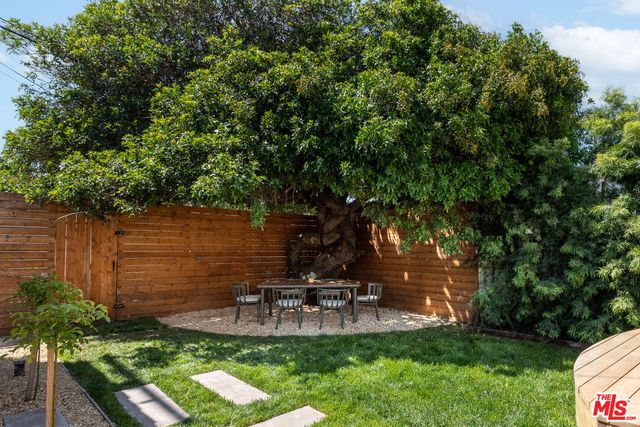 a living room with furniture a fireplace and a chandelier