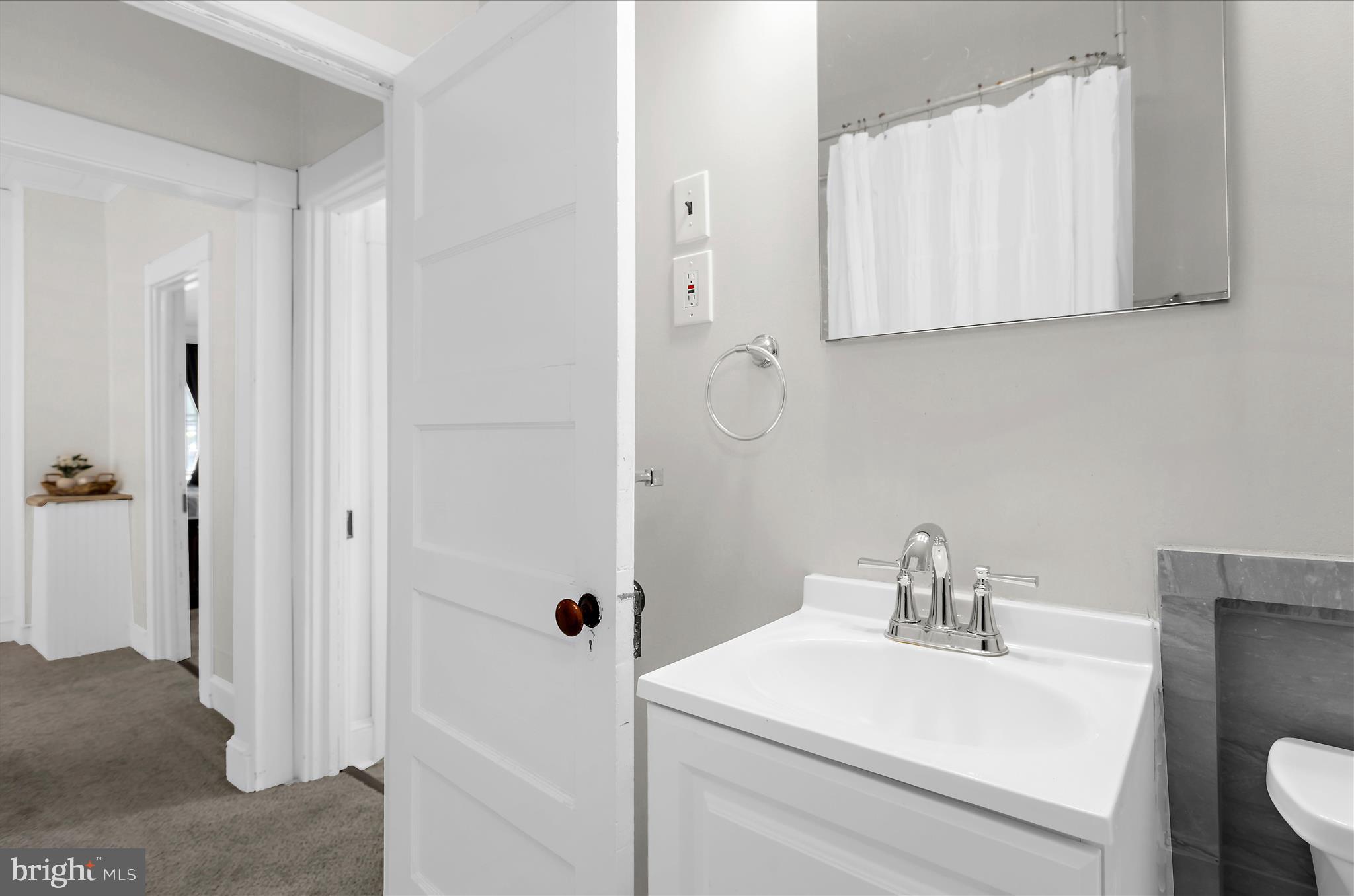 222 Wanda Road Pasadena, MD 21122 - Photo 21 of 34 a bathroom with a sink and a mirror