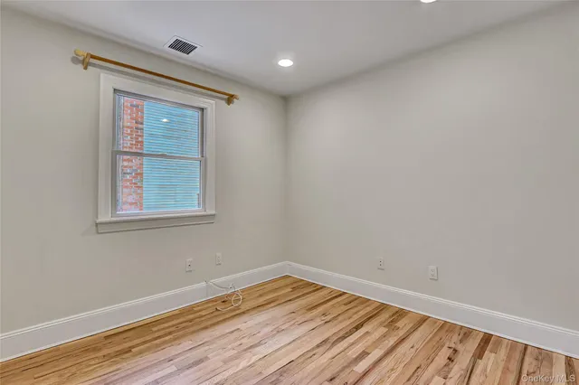 a view of room with furniture and wooden floor