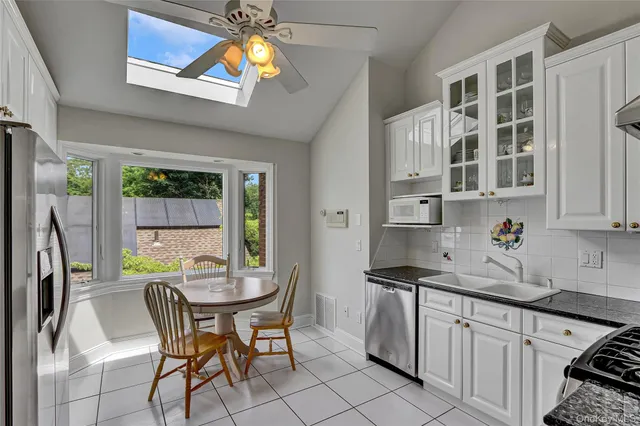 a living room with furniture a chandelier and a wooden floor