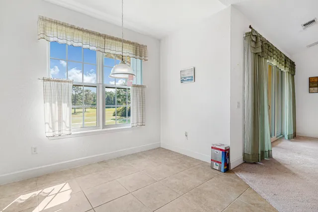 a view of a livingroom with a ceiling fan and window