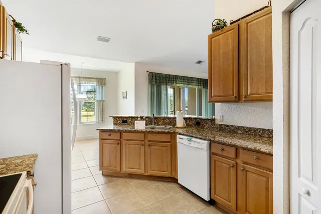 a kitchen with stainless steel appliances granite countertop a stove and a refrigerator