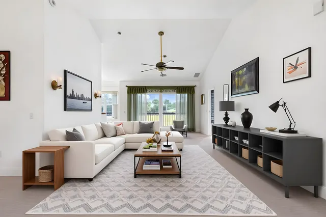 a living room with furniture flat screen tv and window