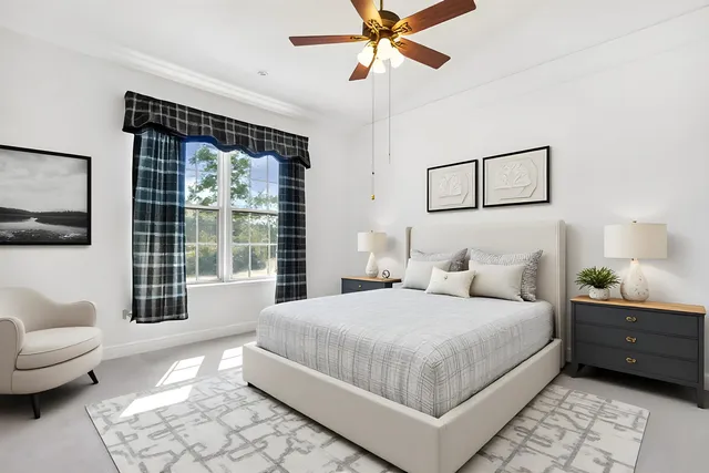 a bedroom with a bed couch and window