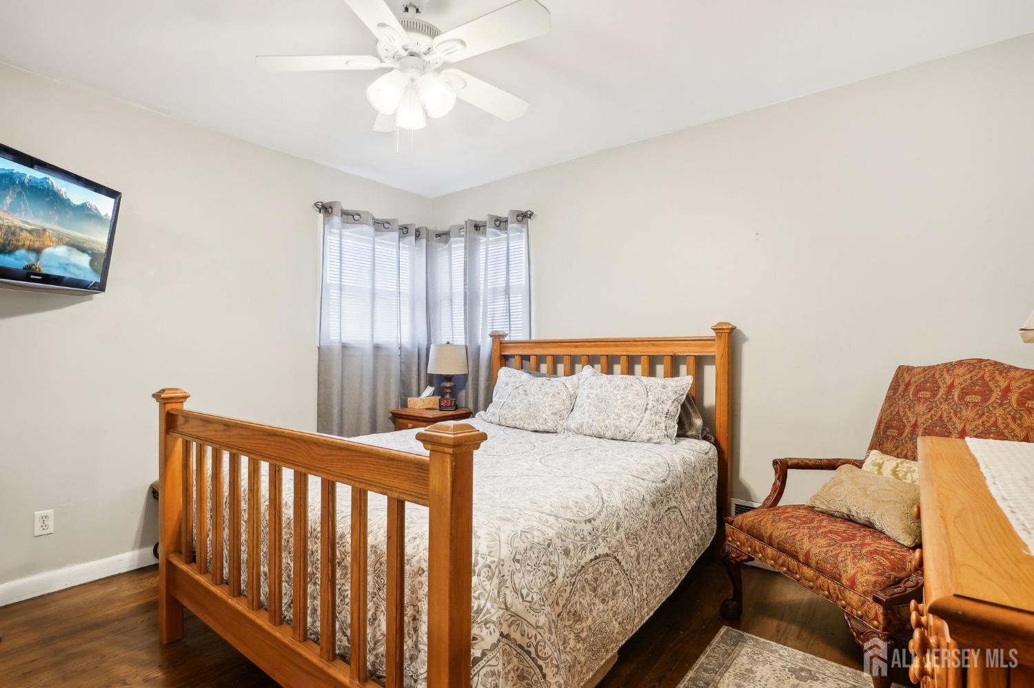23 Brox Road Edison, NJ 08817 - Photo 11 of 33 a bedroom with a bed and a chandelier