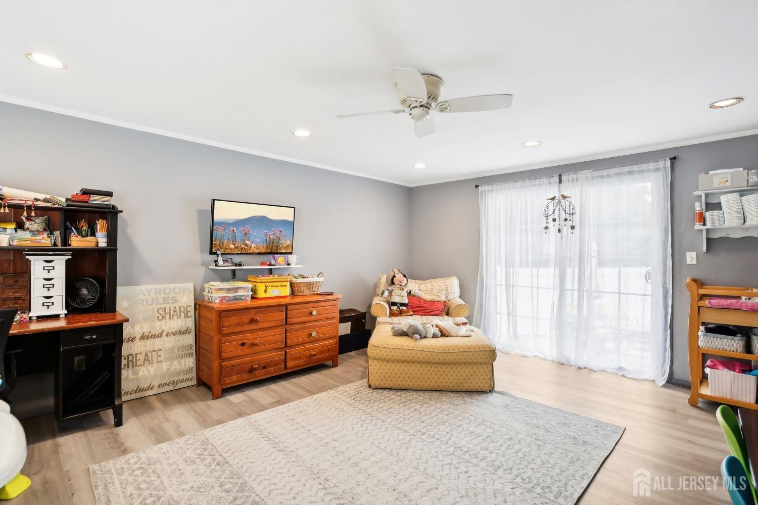 23 Brox Road Edison, NJ 08817 - Photo 12 of 33 a bedroom with furniture and a flat screen tv