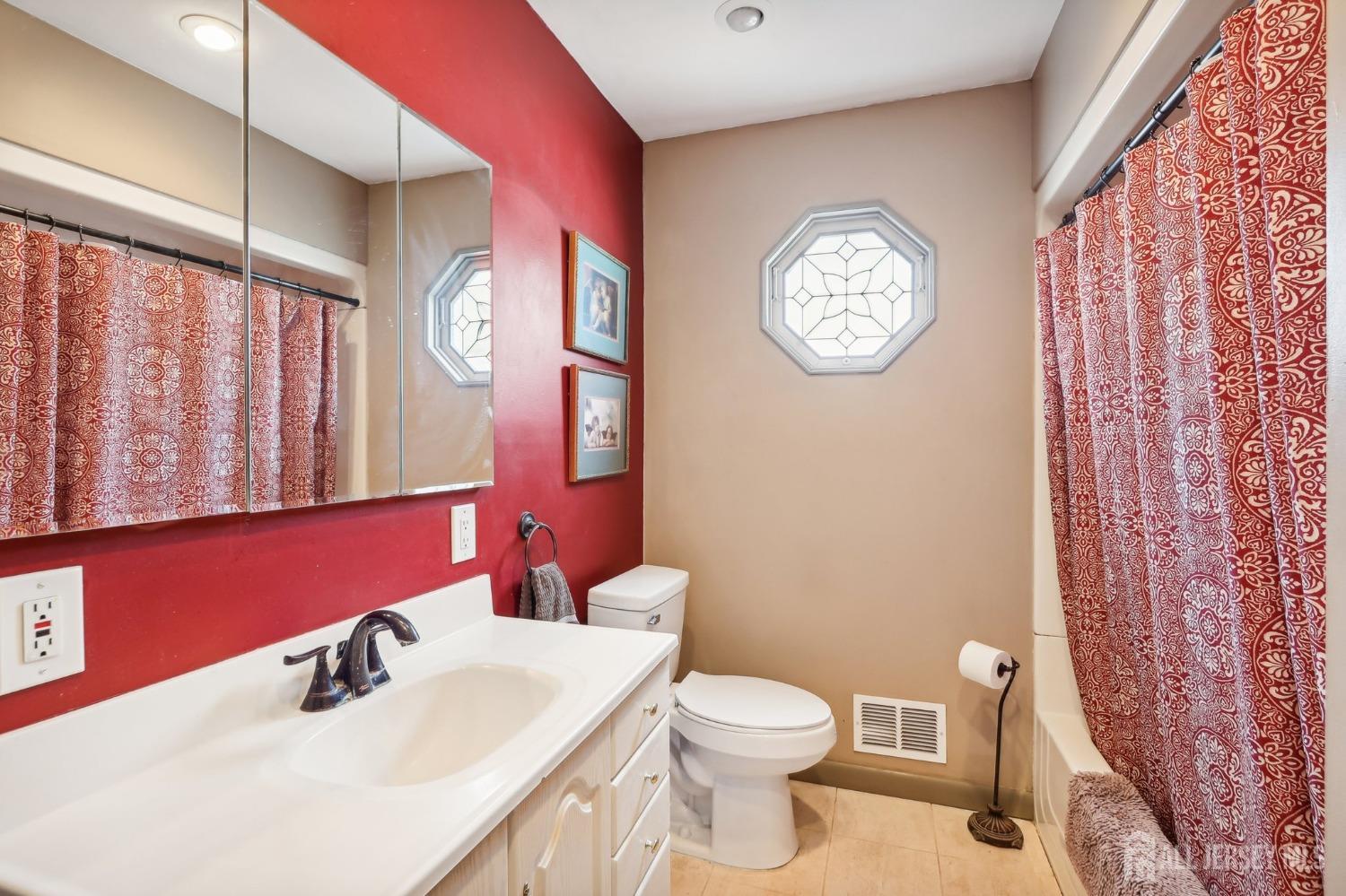 23 Brox Road Edison, NJ 08817 - Photo 13 of 33 a bathroom with a toilet a sink and a mirror