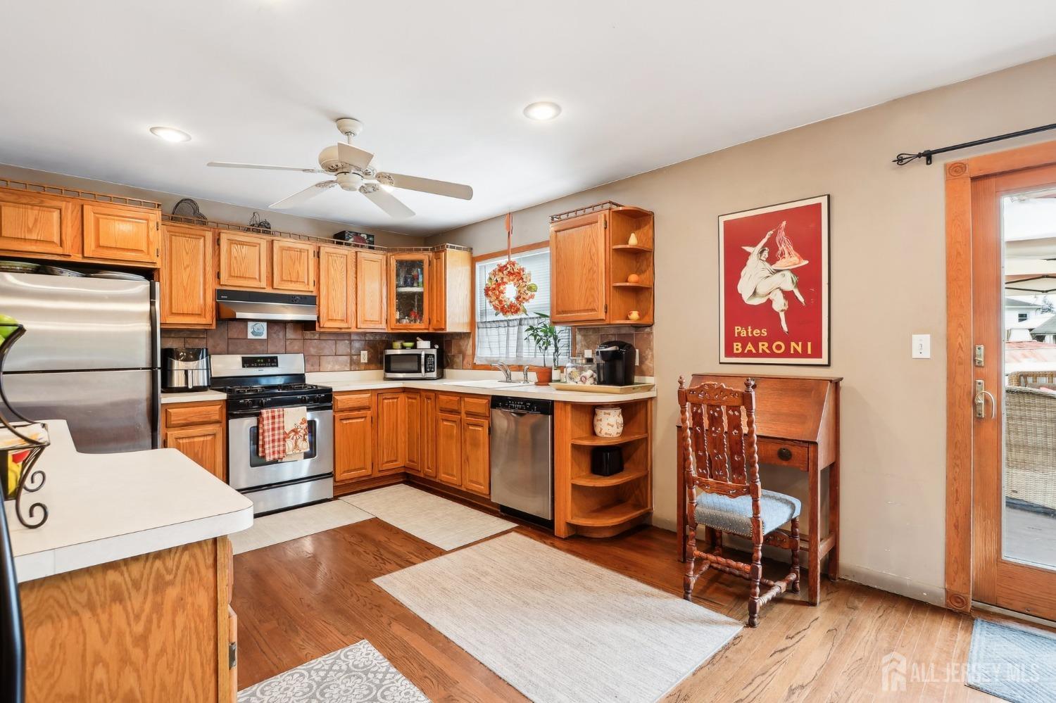 23 Brox Road Edison, NJ 08817 - Photo 7 of 33 a kitchen with stainless steel appliances granite countertop a refrigerator oven a sink dishwasher and white cabinets with wooden floor